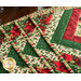 Six Christmas themed placemats with florals, on wood table