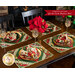 Six Christmas themed placemats on wood table with wine glasses, poinsettias, and matching cloth napkins. 