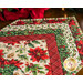 Christmas themed floral table topper on wood table.