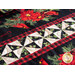 Christmas themed table runner featuring florals with white and black pinwheel center strip design.