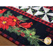 Christmas themed table runner featuring florals, holly, and birds with white and black pinwheel center strip design.