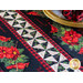 Christmas themed table runner featuring florals with white and black pinwheel center strip design.