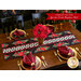 Christmas themed table runner featuring florals with white and black pinwheel center strip design on table set with matching gingham napkins.