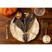 Black cloth napkin with Halloween themed motifs and polka dots.