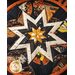 Halloween themed round hot pad with central folded star design with black fabric featuring phrases, Jack-o-lanterns, and witches.