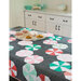 A fun quilt with mint blocks draped over a kitchen table