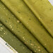 An olive green ombre fabric with metallic accents.