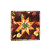 Square hot pad with autumn leaf motifs and central folded star design made with burgundy fabrics sitting on wood table.