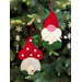 Two Christmas ornaments sewn from fabric, one gnome and one mushroom house.