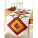 White table runner featuring cardinals and diamond shapes in green, red, and gold.