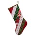 Holiday stocking made from strips of Christmas themed fabric in red, green, and white.