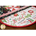 Rounded side of table runner featuring Christmas phrases.