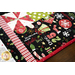 Christmas themed table runner featuring phrases, ornaments, and snowflakes, designed with rounded sides and central pinwheels.