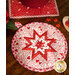 White round hot pad with folded star design made of red and pink Valentine's Day themed fabrics.