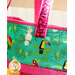 Handle of tote bag made from strips of green, orange, and magenta fabrics featuring jungle animals.