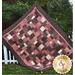 A mauve, cream, and brown example quilt.