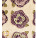 Cream quilt with flowers made of layered purple and green fabric.