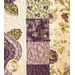Border on cream quilt made from squares of purple and green fabric.