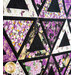Purple and white quilt with triangle geometric design and floral prints.