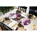 Braided twist being used as table runner on table set with plates and cloth napkins.
