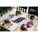 Braided twist being used as table runner on table set with plates and cloth napkins.