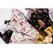 Reversible cloth napkins one side features black fabric with purple butterflies, the other side features white fabric with purple florals.