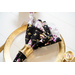 Reversible cloth napkins one side features black fabric with purple butterflies, the other side features white fabric with purple florals on table with matching table runner.