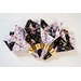 Reversible cloth napkins one side features black fabric with purple butterflies, the other side features white fabric with purple florals.