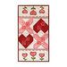 An adorable X's and Hearts table runner with small flowers laid flat on a white background