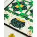 Cream table runner featuring green clovers, pots of gold, and geometric designs.