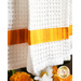 White waffle textured towel with gold and yellow streaked band.