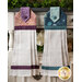 Hanging towel made of orange and purple fabrics next to matching towel in teal.