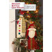 Photo of two fabric bottle covers, one a snowman and one Santa, positioned in front of a Christmas tree.