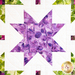 A quilt with geometric square and triangle designs made of multicolor fabrics on white.