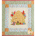 Quilt block featuring a bee hive, florals, and a decorated egg.