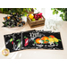 Black placemats with prints of fruits, vegetables, and produce themed phrases splayed on table with matching cloth napkins.