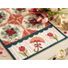 Table runner with four blocks of geometric designs in floral printed fabrics along with umbrella and tulip appliqué on both ends of the runner.