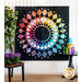 Quilt with circular geometric patterns arranged in a multicolored rainbow gradient on black background.