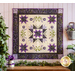 Wall hanging with geometric shapes and florals with vines made of purple and cream fabrics.