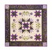 Colorful quilt featuring a central star design surrounded by floral patterns and bold geometric shapes.