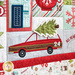 Close up of Patchwork quilt featuring Christmas themed motifs including a family car holding a tree.