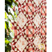 Red, Pink, and Cream quilt with geometric designs made of floral fabrics.