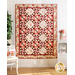 Red, Pink, and Cream quilt with geometric designs made of floral fabrics hanging on wall.