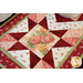 Red, pink, and cream table runner with geometric designs and floral prints.