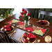 Table runner with interlocking heart design featuring rose themed prints in red, black, and green.