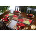 Table runner with interlocking heart design featuring rose themed prints in red, black, and green.