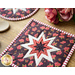 Square hot pads with central folded star design made of floral red, and white fabrics.