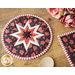 Round hot pads with central folded star design made of floral red, and white fabrics.