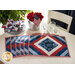 Placemats made of strips of patriotic printed red, white, and blue strips of fabric in a diamond design.