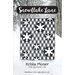 The front cover of the Snowflake Lane quilt pattern featuring a black and white quilt with snow and trees in the background